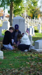 Family placing flags at Mt. Olivet Cemetery