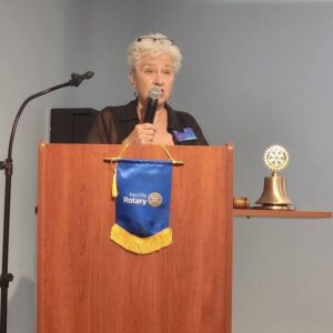 Pat speaking at podium